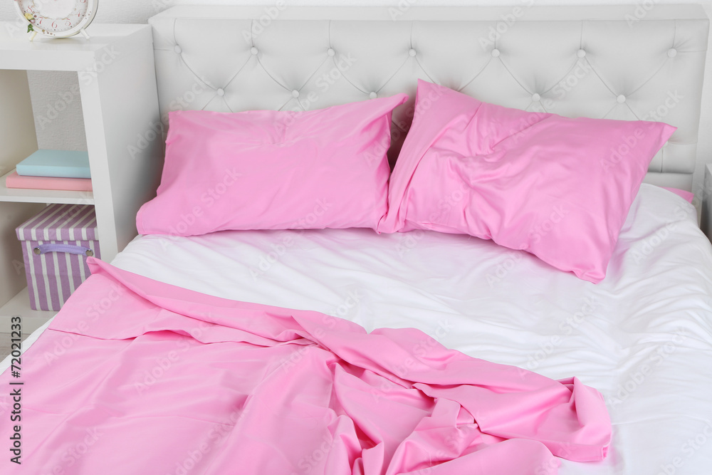 Crumpled pink linen on bed