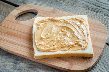 Wall Mural - Sandwich with peanut butter on the wooden board