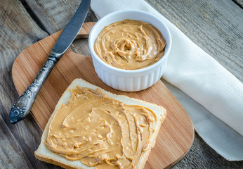 Sandwich with peanut butter on the wooden board