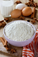 Wall Mural - Flour in bowl with eggs, milk, cinnamon sticks and anise star