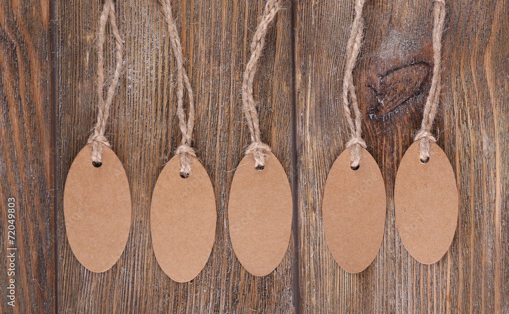 Brown tags on wooden background