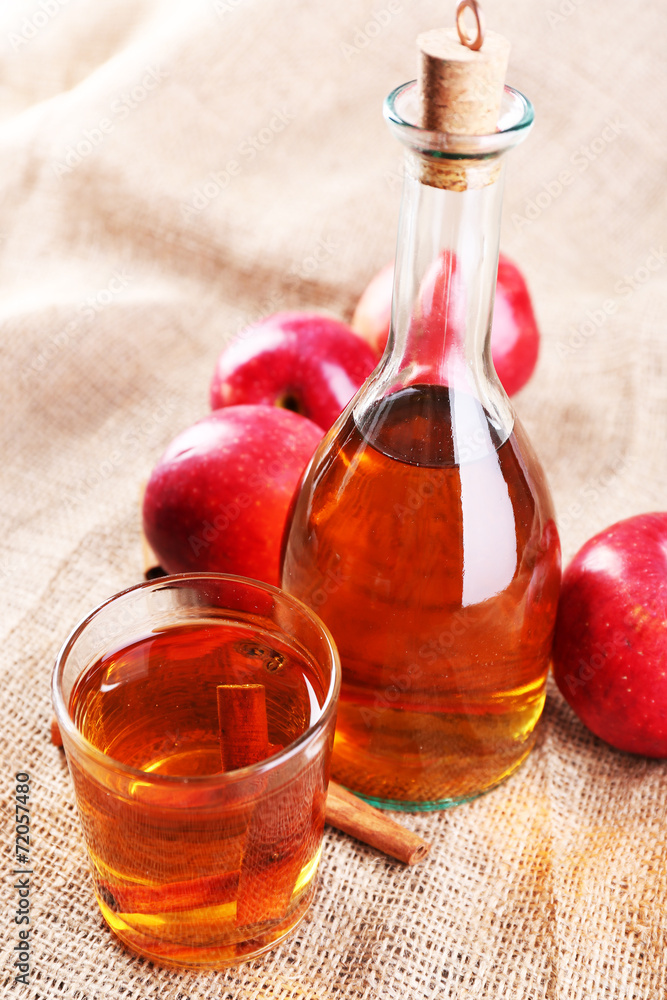 Apple cider with cinnamon sticks and fresh apples