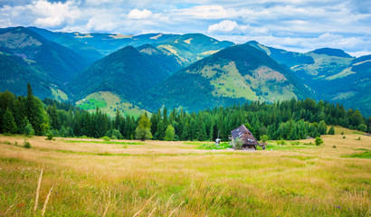 Wall Mural - amazing mountain landscape with fog and a haystack