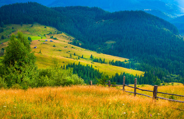 Wall Mural - amazing mountain landscape with fog and a haystack
