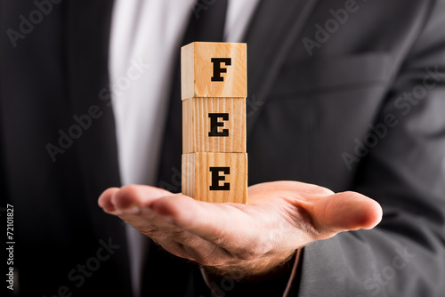 Fotografía Businessman holding wooden blocks reading Fee