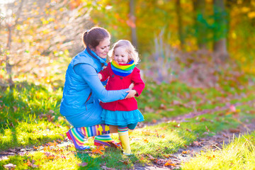 Wall Mural - Beautiful mother and daughter in a park