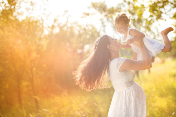 Wall Mural - Pregnant mother with her little daughter in nature