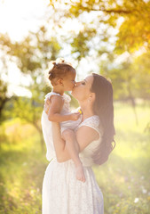 Wall Mural - Pregnant mother with her little daughter in nature