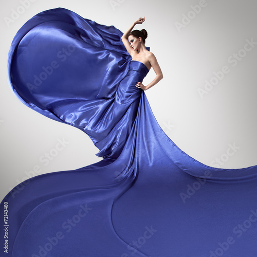 Obraz w ramie Young beauty woman in fluttering blue dress.