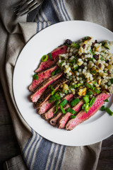 Wall Mural - Sliced steak with couscous and vegetables