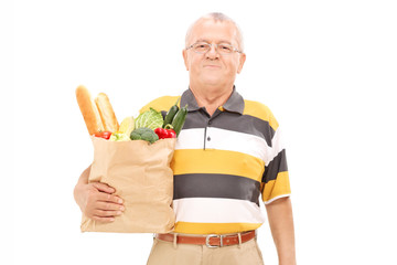 Canvas Print - Senior walking with a bag of groceries