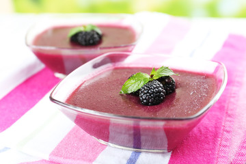 Wall Mural - Delicious berry mousse in bowls on table close-up