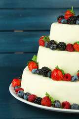 Wall Mural - Beautiful wedding cake with berries on  dark wooden background