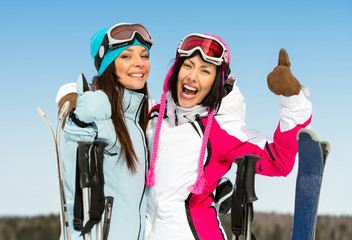 Half-length portrait of two female downhill skier friends 