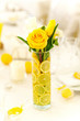 Yellow roses in vase with lemon