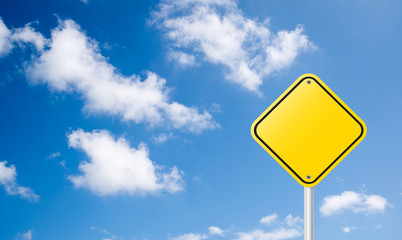 blank yellow traffic sign with blue sky background