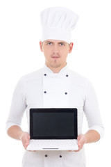 Wall Mural - young man in chef uniform holding laptop with blank screen isola