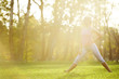 © nenadaksic - Young woman stretching in the park