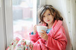 © Alinute - Beautiful little girl in bathrobe with cup of tea