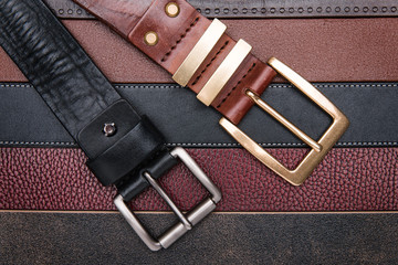 Wall Mural - Close-up of two men belts