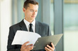 © michaeljung - businessman reading monthly report