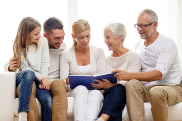 Wall Mural - happy family with book or photo album at home