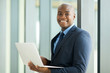 © michaeljung - young african businessman using laptop computer