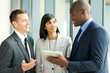 © michaeljung - multiracial businesspeople working on tablet pc