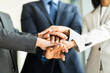 © michaeljung - multiracial business people putting their hands together