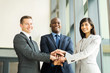© michaeljung - multiracial business team putting hands together