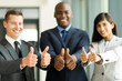 © michaeljung - multiracial business team giving thumbs up