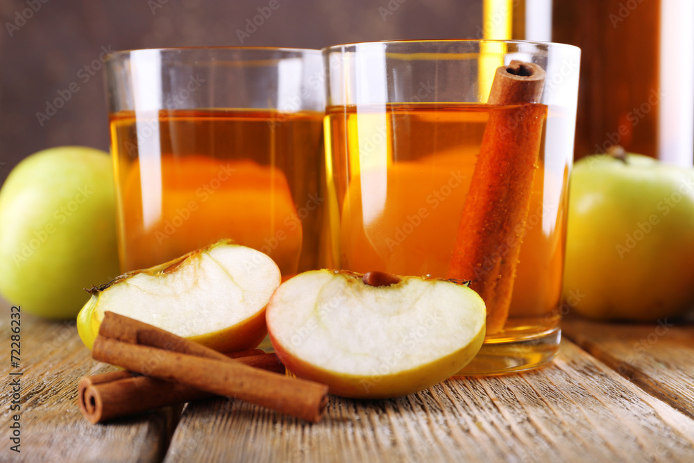 still life with apple cider and fresh apples on wooden table