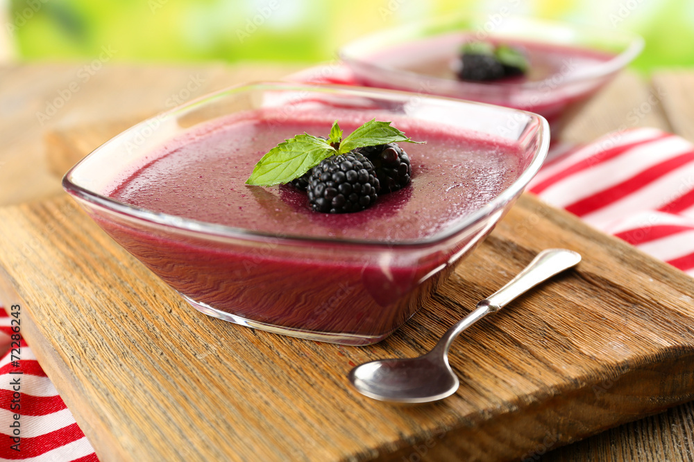 Delicious berry mousse in bowls on table close-up