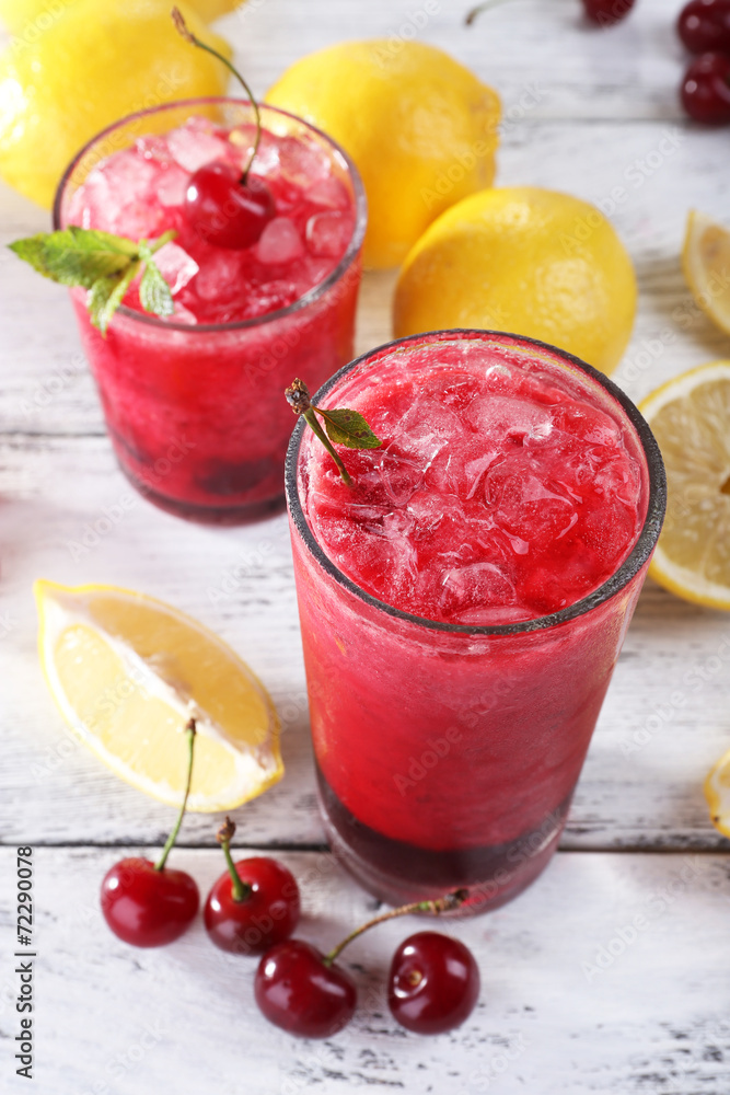 Fresh cold cherry cocktail with mint, ice and lemon
