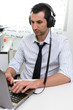 © Studio Gi - Businessman with laptop and headphones, selective focus