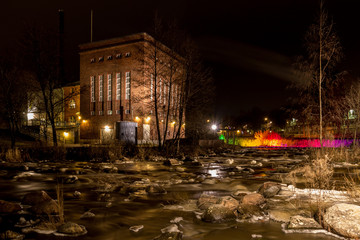 Old factory by the river at night