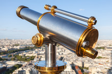 Shining Telescope Mounted On The Railings Of Eiffel Tower