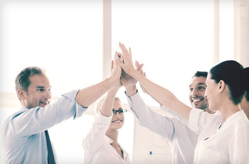 Canvas Print - happy business team giving high five in office