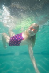 Cute kid posing underwater in pool