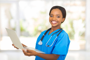 african medical worker holding laptop computer