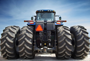 Fototapete - Farm tractor on huge wheels