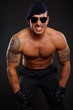 © petrdlouhy - Angry muscular soldier showing his teeth on dark background