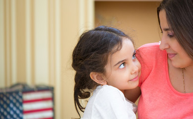 portrait of lovely hispanic mother and daughter