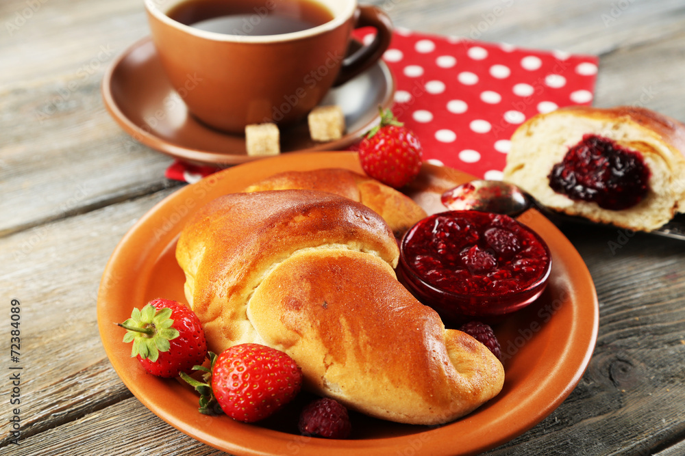 Breakfast with tea and  big fresh croissant on wooden