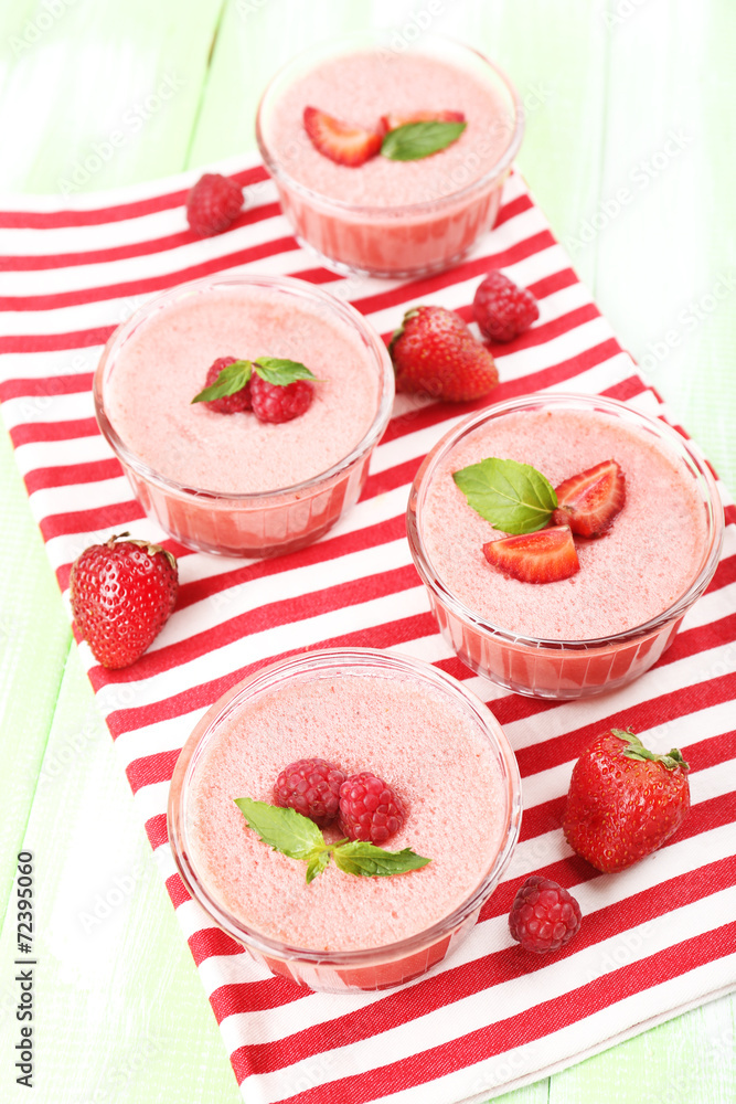 Delicious berry mousse in bowls on table close-up