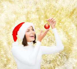 Wall Mural - woman in santa helper hat with christmas ball