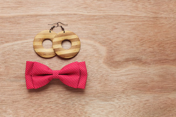 Wooden earrings and red bow tie