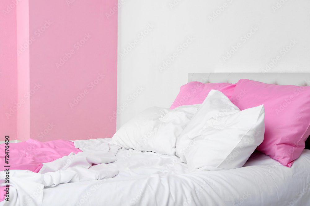 Crumpled pink linen on bed
