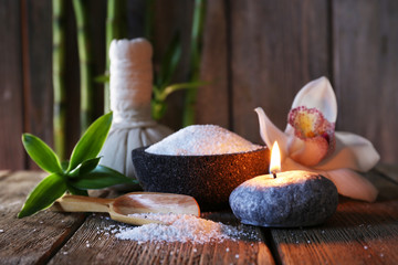 Spa set on wooden surface on wooden wall background