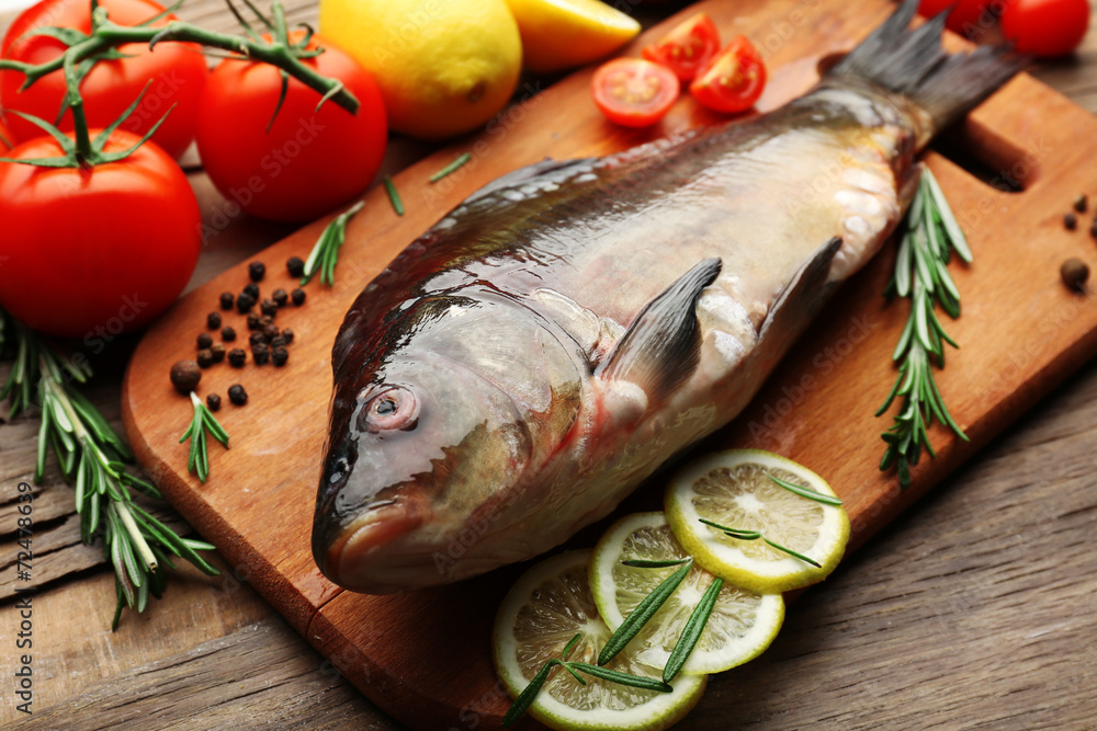 Fresh raw fish and food ingredients on table